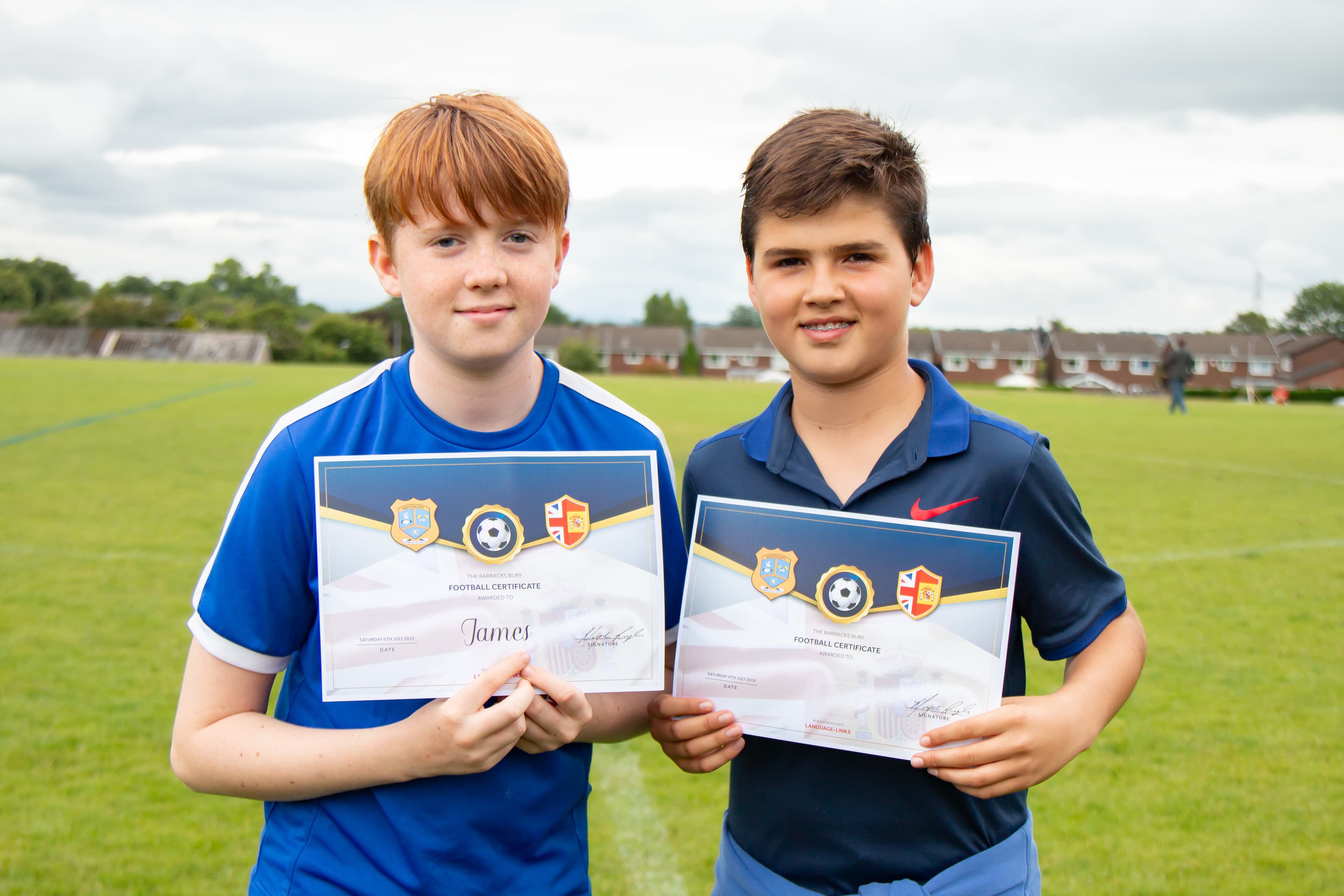 English and Spanish students receiving football certificates together